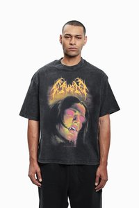 Black oversized graphic t-shirt with a distressed texture, featuring front artwork of a stylized face with vibrant orange and pink accents.
