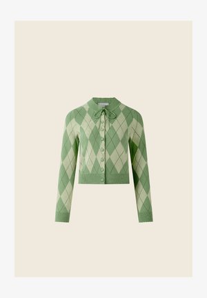 Zöld argyle kardigán masnis nyakkivágással, bordázott mandzsettákkal és szegéllyel, valamint gombos elöl. Világos és sötétzöld gyémántmintákkal díszítve.