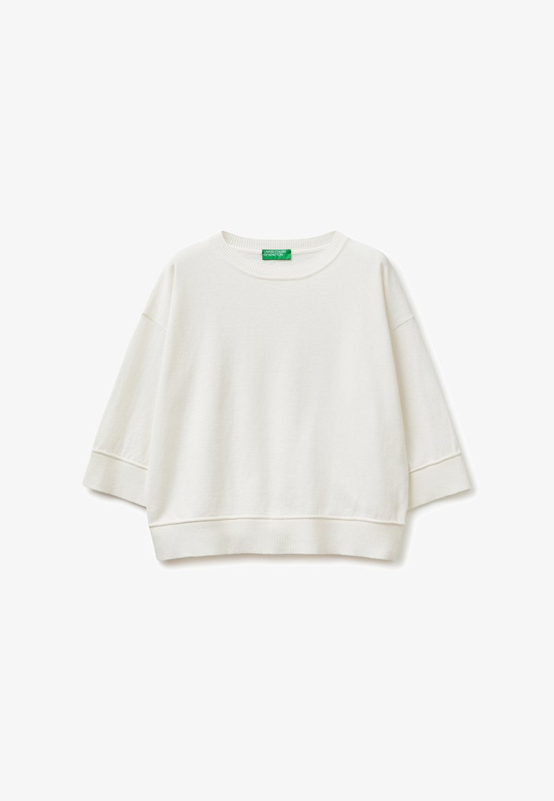 Sudadera blanca recortada con mangas anchas hasta el codo y cuello, puños y dobladillo acanalados, con una etiqueta de marca verde en el interior del cuello.