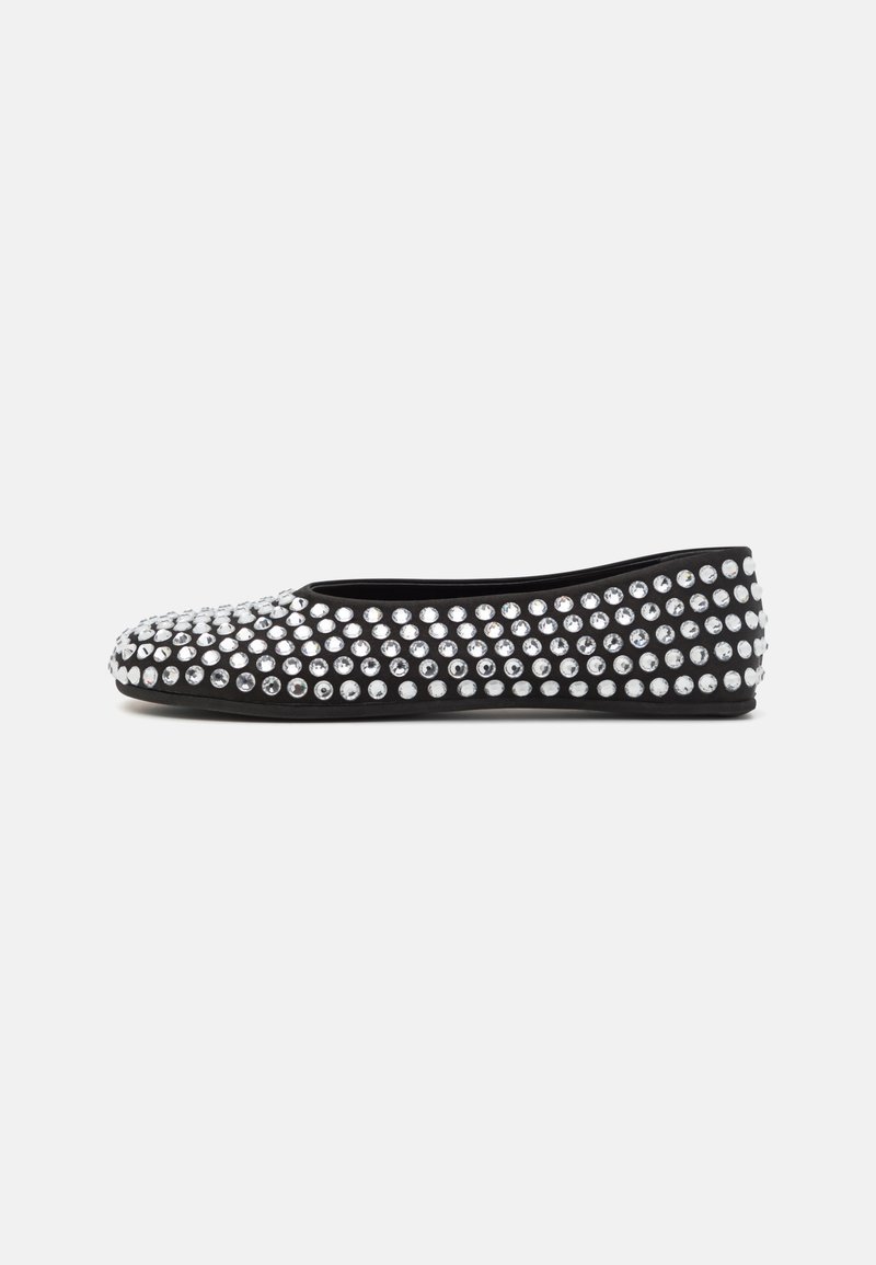 Black flat shoe adorned with silver studs, featuring a rounded toe and a smooth, flexible upper material. Simple silhouette suitable for casual wear.