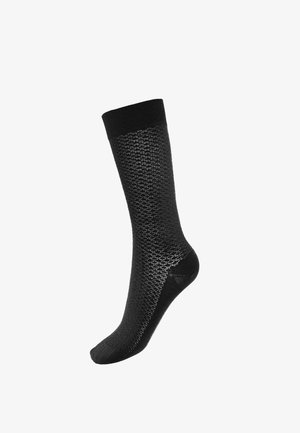 Calzino nero fino al ginocchio con motivo a diamante testurizzato, polsino elastico e punta rinforzata. Realizzato con un tessuto misto morbido e traspirante.