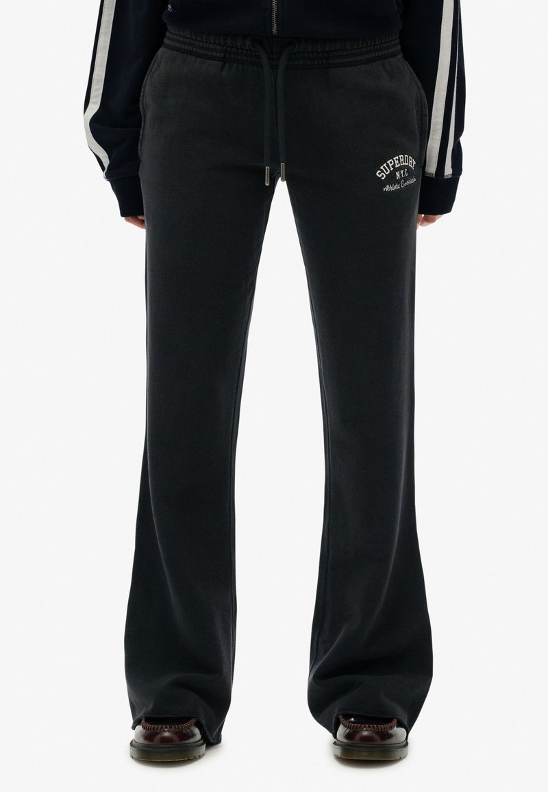 Sorte bomulds sweats med en afslappet pasform, der har elastisk talje, snøre og et hvidt logo trykt på underbenet.