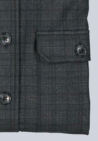 Gray patterned fabric with a subtle check design, featuring two black buttons and a flap pocket for functional detail.