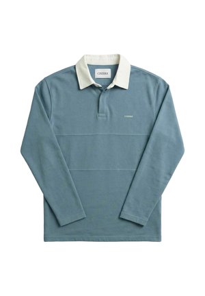 Blauw rugbyshirt met lange mouwen, witte kraag en klein "CISZERE" logo op de borst, plat gelegd op een witte achtergrond.