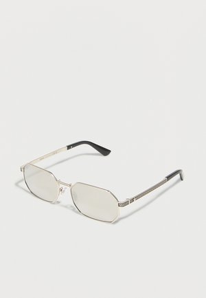 Silver-framed rectangular sunglasses with clear lenses and black temple tips featuring a decorative geometric pattern on the arms.