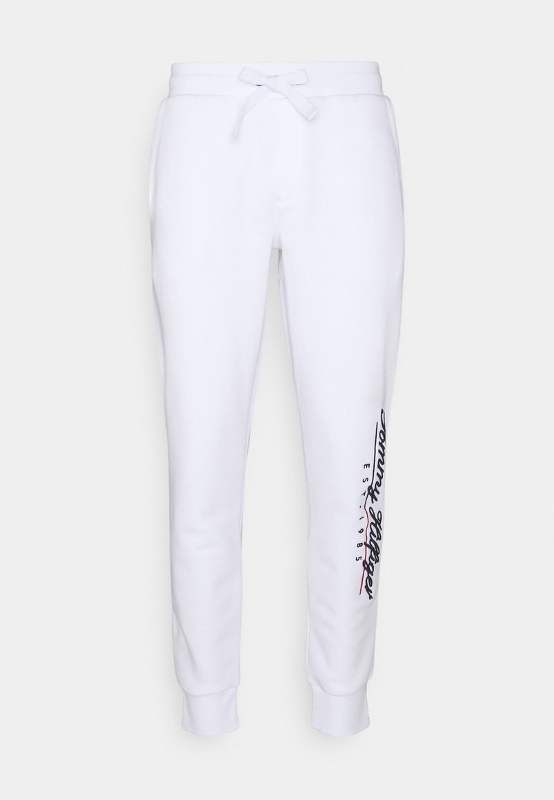 White sweatpants made of cotton blend, featuring a drawstring waist, tapered legs, and side logo in black and red text along the left leg.