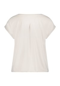 Krótki rękaw, jasnobeżowa bluzka o luźnym kroju, z delikatnym plisowaniem z tyłu i miękką fakturą dla wygody.