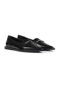Black leather loafers with pointed toes, decorative perforated pattern, a silver accent, and a low flat sole. Smooth, shiny finish.