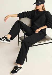 Next Široké džíny - black