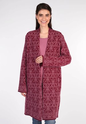Long, burgundy cardigan made of textured fabric with intricate light pink patterns, open front, and wide sleeves. Layered over a pink top.
