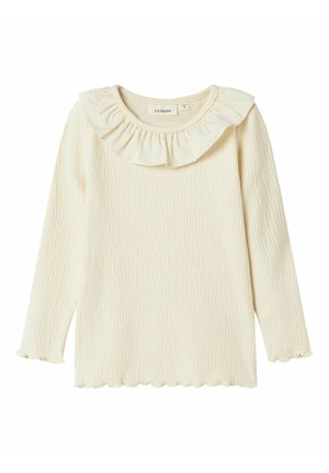 Chemise à manches longues pour tout-petit de couleur crème avec tissu texturé, col à volants et ourlet et poignets festonnés.