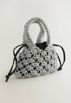 Musta samettinen käsilaukku, jossa on hopeista helmiverkkoa, ympyränmuotoinen yläkahva ja narukiristys, esittelee monimutkaisia kudontakuviota.