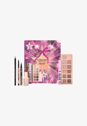 Coffret de maquillage avec un packaging rose et violet, présenté avec un nœud et des graphiques d'étoiles. Comprend une palette de fards à paupières, un eyeliner, un gloss à lèvres et des crayons.