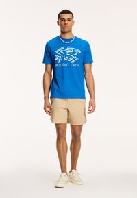 Shiwi Triko s potiskem - skydive blue