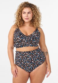 Black floral bikini featuring a ruffled bralette and high-waisted bottom, adorned with small blue, white, and brown flowers. Soft fabric.