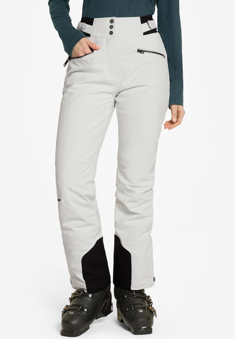 Pantalones de esquí en gris claro con detalles en negro, que cuentan con una cintura alta, bolsillos con cremallera y un diseño ajustado. Fabricados con un material duradero y resistente a las inclemencias del tiempo.
