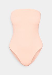 Brezramni enodelni kopalni kostim v svetlo breskvenasti rebrasti tkanini. Ima gladko teksturo in eleganten kroj z visokim izrezom na straneh.