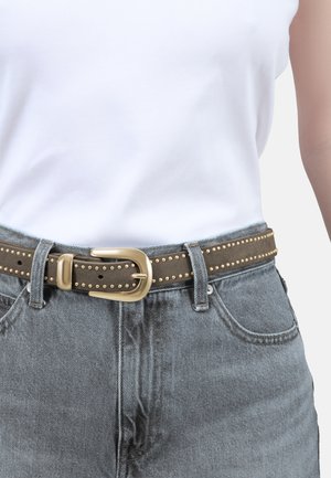 Brown fabric belt with gold studs, featuring a brass buckle. Worn with light grey denim jeans and a white top. Simple design, textured finish.