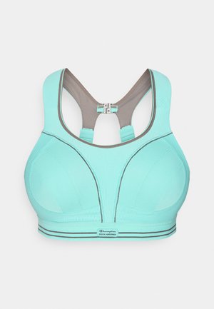 Reggiseno sportivo verde menta con design senza cuciture, spalline grigie regolabili e chiusura con gancio. Tessuto strutturato e dettagli scuri a contrasto.