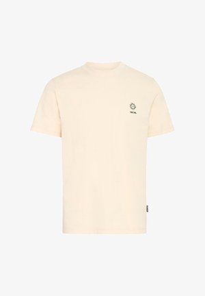 Krém színű pamut póló kerek nyakkal, rövid ujjakkal, és egy kis fekete nap grafika, valamint szöveg a bal mellrészen.