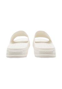 White slide sandals with a textured footbed and raised edges, featuring a branding label at the heel and open top for breathability.