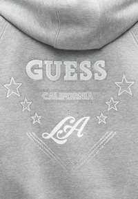Γκρι φούτερ με κεντημένο κείμενο "GUESS CALIFORNIA" και "LA" με ασημί αστέρια και διακοσμητικά από στρας.