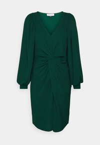 Robe longueur genou vert foncé avec de longues manches bouffantes, décolleté en V profond et détail de nœud torsadé à la taille.