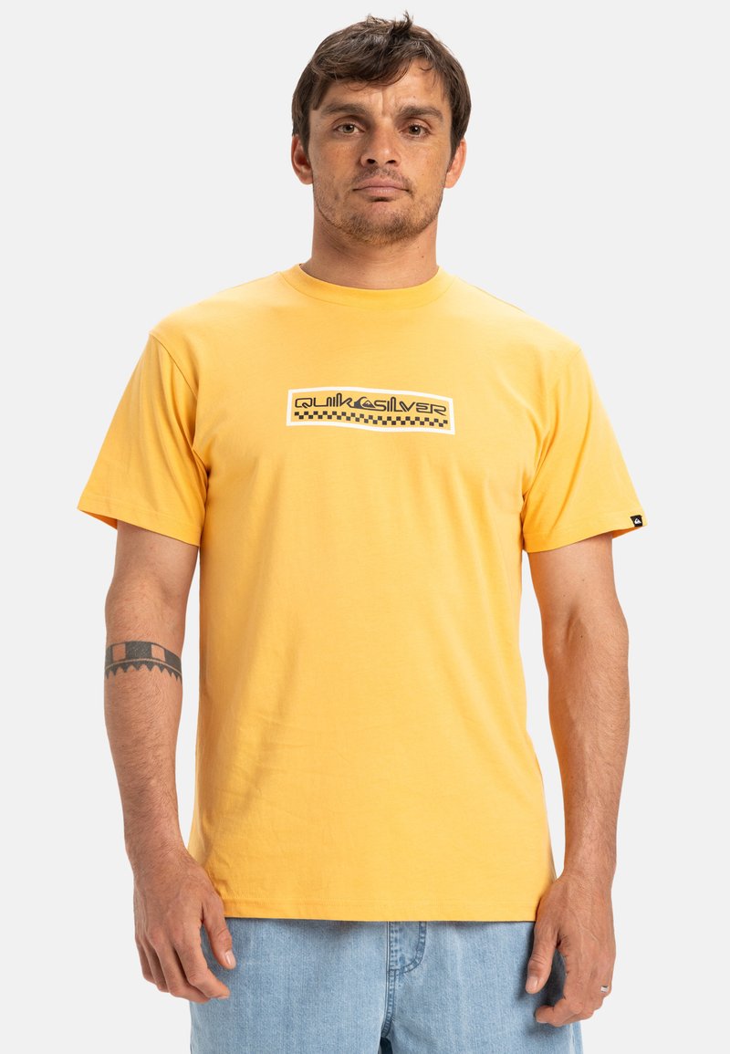 Yellow cotton t-shirt with a round neckline, featuring a black and white logo design across the chest, short sleeves, and a relaxed fit.