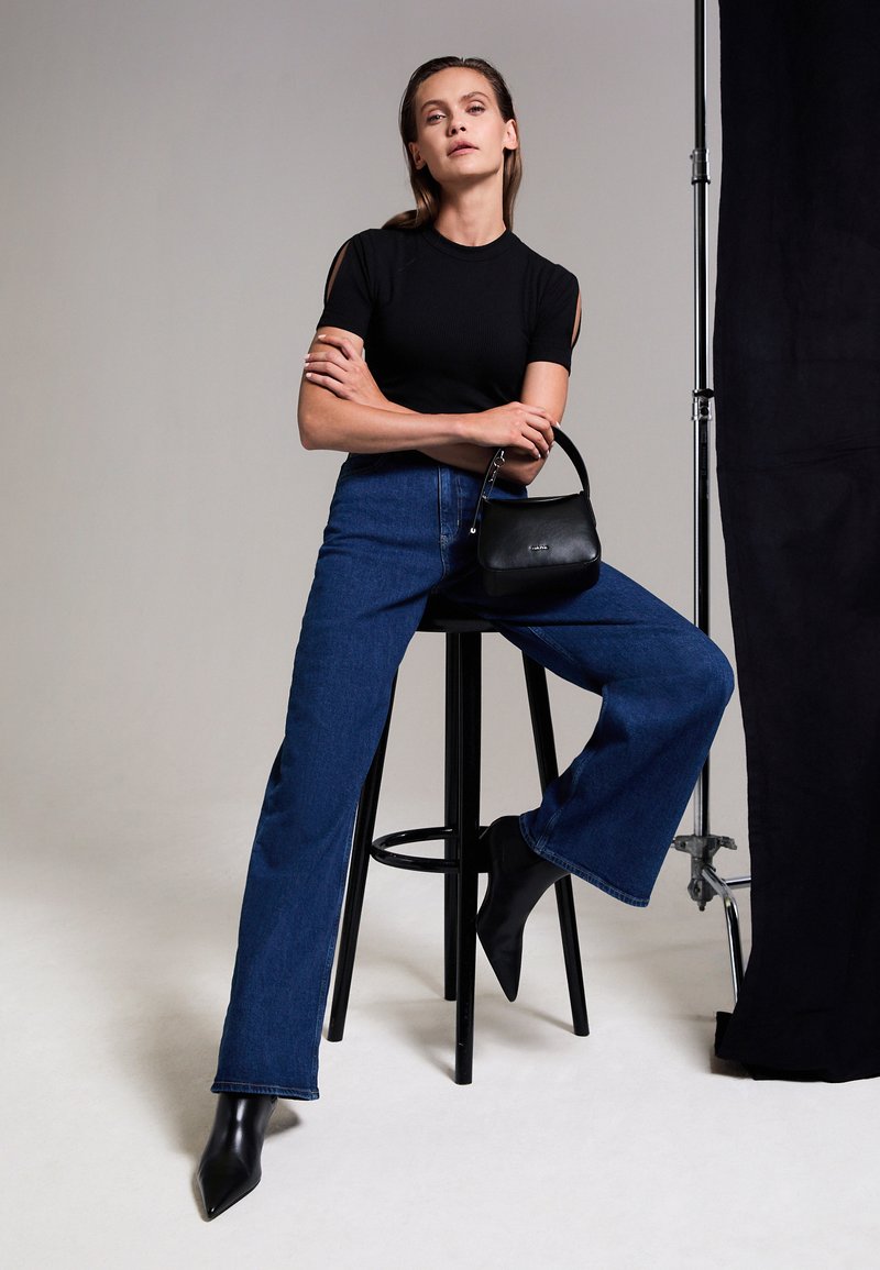 Calvin Klein WIDE STONE - Wide leg - denim dark