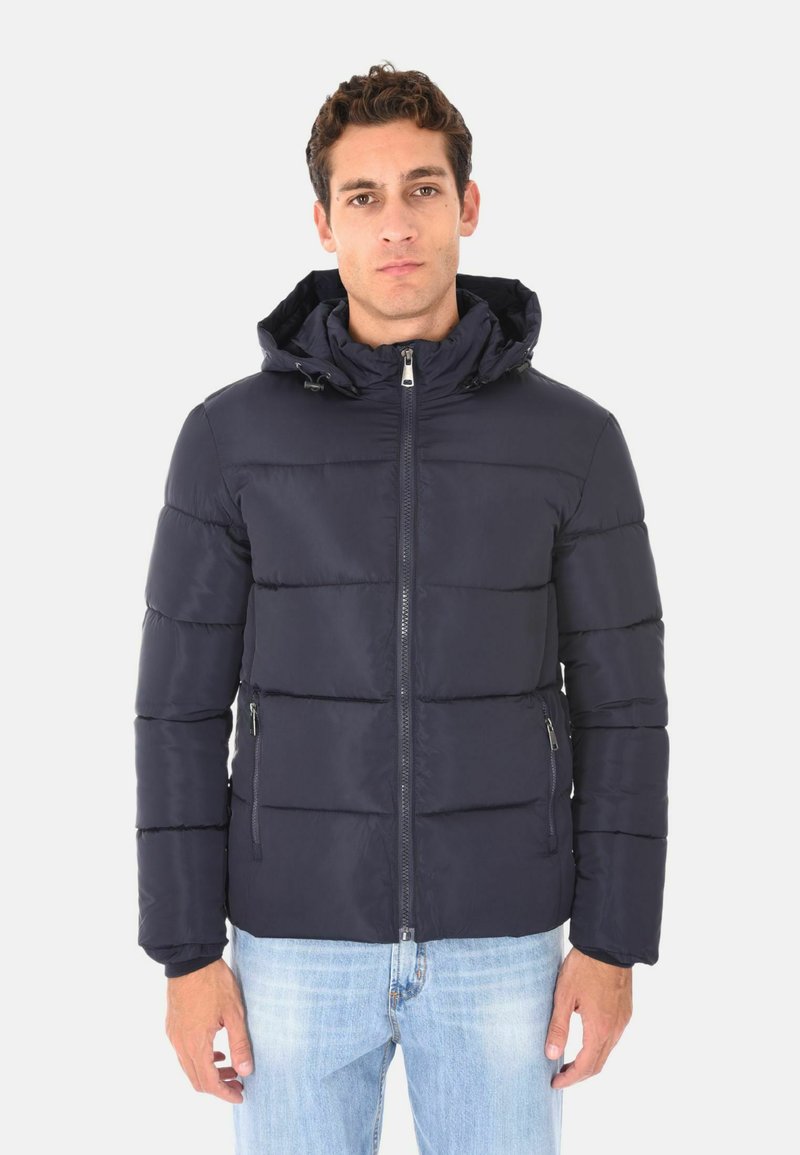 Giacca puffer blu navy con sezioni trapuntate orizzontali, chiusura con zip e cappuccio fissato. Presenta due tasche laterali con zip.