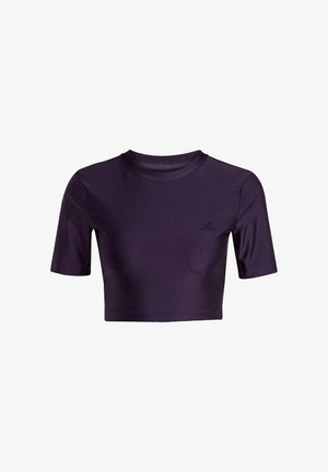 Purppurainen lyhythihainen cropped t-paita, joka on valmistettu sileästä kankaasta. Siinä on pyöreä kaula-aukko ja hienovarainen logo vasemmalla etupuolella.