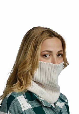 Knit neck gaiter in light beige with ribbed texture, featuring a foldover design. Worn by a person in a green and white plaid shirt.