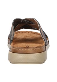 Brown leather sandals with cross straps, textured insole, and a light-colored rubber outsole. Stitching detail along the edges is visible.