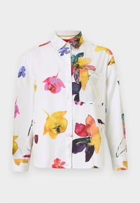 White button-up shirt featuring a colorful floral print in pink, yellow, and blue. Includes a chest pocket and long sleeves.