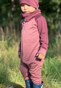 Maroon jumpsuit with long sleeves and a zip front, paired with a matching hat and blue rubber boots. Features a snug fit and soft texture.