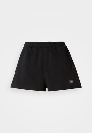 Svarta shorts i mjukt tyg, med elastisk midja, rak passform och en liten logotagg på nedre vänstra sidan.
