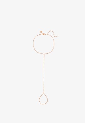 Delicate rose gold chain bracelet with extended loop designed to encircle a finger, featuring a small sun-shaped charm near the clasp.
