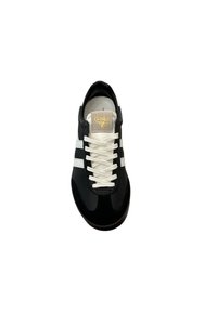 Black sneaker with white stripes, smooth leather upper, round toe, white laces, and a gold Gola logo on the tongue. Flat rubber sole.