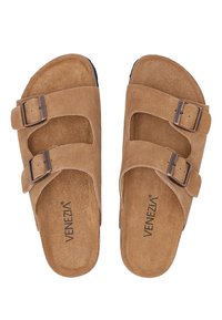 Brown suede sandals with two adjustable straps, featuring bronze buckles. Curved footbed design with a textured insole and flat sole.