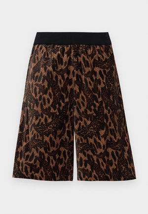 Bruna och svarta djurtryck bredbenade shorts med ett svart elastiskt midjeband, uppvisade mot en vit bakgrund.