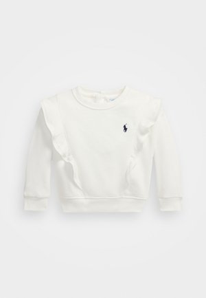 Balts džemperis ar ruffles detaļām uz pleciem, apaļu kakla izgriezumu, garām piedurknēm un mazu tumšu logo kreisajā krūtī. Mīksts kokvilnas materiāls.