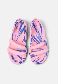 Pink rubber sandals featuring blue abstract patterns, with three thick straps crossing over the top and a textured sole for grip.