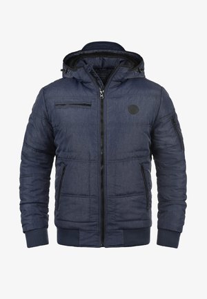 Tumesinist värvi pehmendatud jope lukuga esiküljel, reguleeritava kapuutsi ja soonikkoes varrukapitsidega. Omab mitmeid lukuga taskuid ja tekstureeritud kangast.