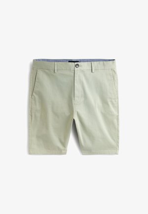 Pantaloncini di cotone verde chiaro con chiusura a bottoni, due tasche laterali e un design a contrasto sulla fascia interna della vita. Tessuto liscio e vestibilità su misura.