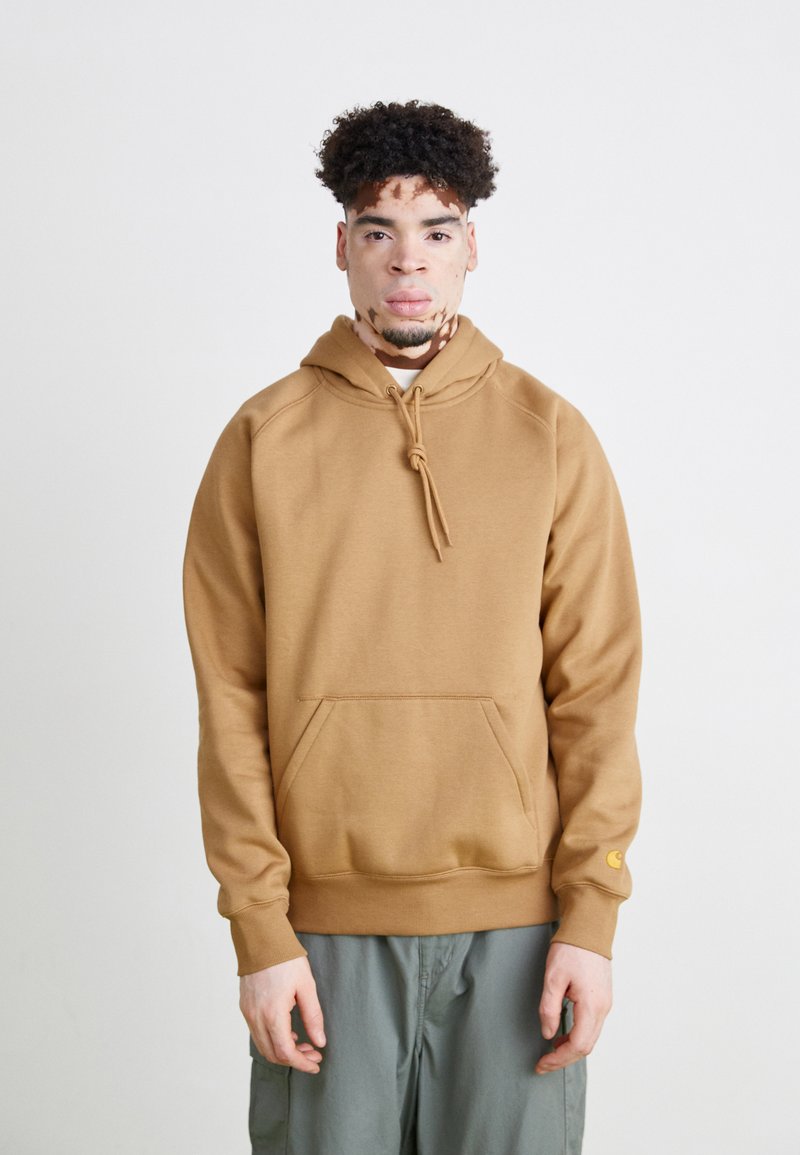 Brown hooded sweatshirt with a front pocket, drawstring closure, and ribbed cuffs. Smooth texture and relaxed fit.