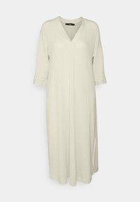 Robe crème ample longueur genou avec col en V, manches trois-quarts et texture de tissu douce, présentée sur un fond clair.