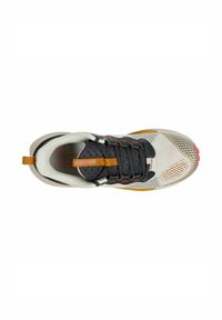 Zapatilla deportiva ligera con una parte superior de malla negra y gris, detalles en naranja y una suela de goma texturizada. Presenta cordones y un tirador.