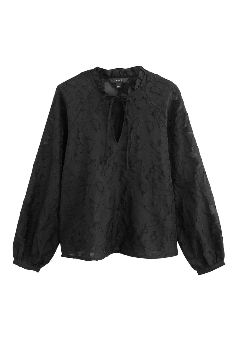 Blusa nera con maniche lunghe, motivo floreale testurizzato e scollo con apertura a goccia. Caratterizzata da una vestibilità comoda e polsini elastici.