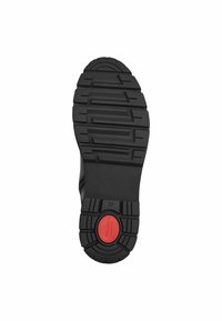 Semelle de chaussure noire avec des profondeurs de crantage, en caoutchouc texturé, accent rouge circulaire, et taille "37" marquée au fond pour une meilleure adhérence et stabilité.