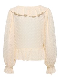 Blouse crème à manches longues avec pois texturés, col à volants et poignets froncés avec détails à volants.